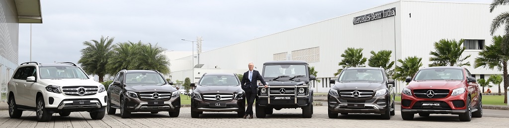 Mr. Roland Folger posing with the entire range of petrol SUVs from Mercedes-Benz